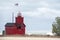 Red Michigan lighthouse in windstorm