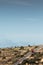 A red minivan driving down a hill in the Maltese countryside, just outside of Mellieha. Malta, 8th January 2017