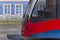 Red modern public electronic railway tram on street close