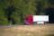 Red modern semi truck and trailer summer high way