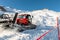 Red modern snowcat ratrack with snowplow snow grooming machine preparing ski slope piste hill at alpine skiing winter resort