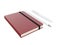 Red moleskine or notebook with pen and pencil and a black strap front or top view isolated on a white background 3d rendering