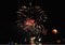 Red moon and fireworks near river in night