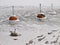 Red mooring buoys in deep frozen lake