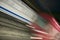 Red motion blur of speeding train at Metro subway train station in Madrid, Spain