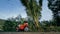 The red motorbike on forest road trail trip. One scooter, near tropical palm tree. Asia Thailand ride tourism. Single