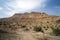 Red mountain in Ein Gedi National park, Israel. Agricultural plantation in an oasis in the Desert. High cliff on the background of