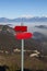 Red mountain guidepost along an alpine pathway