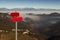 Red mountain guidepost along an alpine pathway