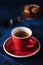 Red Mug of aromatic espresso on a blue table