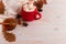 Red mug with cocoa and marshmallows, on a background of a scarf and dry leaves. Autumn mood, a warming drink