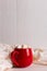 Red mug with cocoa and marshmallows on a white table scarf background. Autumn mood, a warming drink. Copy space