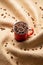 Red mug with coffee beans on twisted burlap background