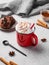 Red mug with hot chocolate or cocoa with whipped cream, cookies, spoon, cinnamon sticks and star anise