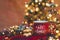 Red mug of hot coffe with Christmas lights, fresh cookies, cream, cinnamon and straw