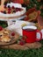 A red mug of tea or strong coffee stands next to a slice of homemade pie