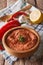 Red Muhammara and ingredients close-up. vertical