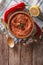 Red Muhammara and ingredients. Vertical top view