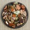 Red and multicolored jasper polished tumblestones on black plate and grey background