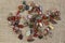 Red and multicolored jasper polished tumblestones on rough linen background