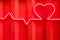 Red neon heart shape and heartbeat line on metal wall