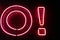 Red neon light letter and exclamation point on a black wall