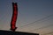 A red neon liquors store sign glowing during a sunset