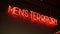A red neon sign with the words men\'s territory hangs on the wall inside a salon