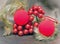 Red New Year\'s ball, decorative berries and tinsel.Christmas still life