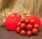 Red New Year\'s ball, decorative berries and tinsel.Still-life