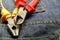 Red nippers yellow side cutter repair electrical engineering electricity close-up on jeans construction background base
