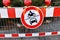 Red `No access to motor vehicles road sign` on red metal barrier in front of christmas market in city center