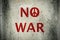 Red No War message and peace symbol graffiti on grunge ciment wa