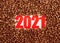 Red number 2021 in coffee beans. The concept of a New year. Flatley