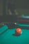 Red, number 3, billiard ball in a pool table. Vintage style noise effect
