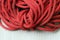 Red Nylon rope texture background on white napery