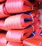 Red nylon soft lifting slings stacked in piles.