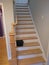 Red oak stairs and handrail with post,unstained new treads during sanding process before stained