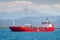 The red oil tanker transports petroleum products