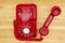 Red old retro rotary landline phone with receiver