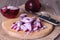 Red onion cuts on a wooden board