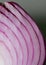 Red onion layers on a gray background