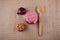 Red onion, wooden box, spoon and jar on sackcloth as background.