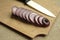 Red onions wooden board slices and white ceramic knife