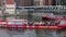 Red open topped canal sight seeing tourism boats maneuvering