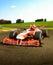 Red open wheeled single-seater  forceful formula race car in a curve