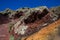 Red, orange and black stratified cliffs in Santorini