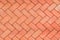 Red-Orange bricks tiled floor with zigzag pattern texture background