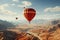 Red orange hot air balloon flies against a partly cloudy sky above a river through a beautiful valley with a backdrop of mountains