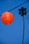 Red/orange lantern with palm tree in background